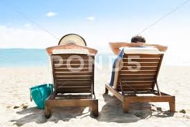 Rear View Of Couple Relaxing On Deck Chairs At Beach Resort Stock Photos Ad Relaxing Deck Couple Rear Deck Chairs Beach Resorts Resort