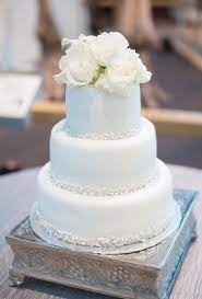 White 3 Tier Round Wedding Cake With Edible Beads And Pearls As Borders And Fresh Flowers As A Topper Rose Gold Wedding Cakes Round Wedding Cakes Wedding Cakes