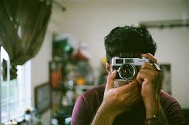 man takes picture with film cam