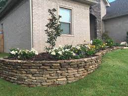 Retaining walls are complete walls that perform as a part of landscaping. Front Yard Retaining Wall With Small Garden Keep It Looking Great Year Round With Our Landscaping Retaining Walls Backyard Landscaping Front Yard Landscaping