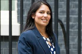 A protestor wears an outfit mocking priti patel (getty images). Zelo Street Migrant Drowning Hello Priti Patel