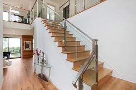 A sisal runner leads the way for guests on this smart, traditional staircase. Modern Staircase With Wood Steps Glass Railing Hgtv