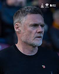 Graham Alexander has accepted an FA charge of misconduct following the  Bantams' Emirates FA Cup tie against Cheltenham Town. The City manager will  serve a one-match touchline ban, which will take place