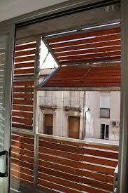 Wooden Louvered Shutter Protecting Balcony 213 Louvered Shutters Facade Design Wooden Shutters