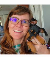 This is one of Belle's happy places! A pile of warm laundry. Yes, I let my  min pin lay