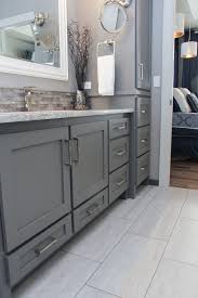 This bathroom uses neutral grays and beiges. White Tile Bathroom Floor And Natural Stone And Glass Tile Vanity Splash White Tile Bathroom Floor White Bathroom Tiles Bathroom Interior Design