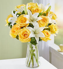 Accented with spiral and seeded eucalyptus, baby's breath, assorted greenery and red bow Fair Trade Certified Yellow Rose White Lily 1800flowers 159655