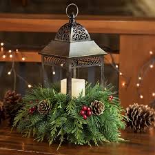 Candle Lantern Centerpiece With Fresh Greens In 2020 Lanterns Centerpieces Christmas Christmas Door Decorations Christmas Arrangements