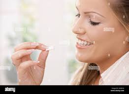 Girl taking chewing gum Stock Photo