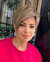 This is me, age 82. How do you like my hair style. I realise it is a little  unorthodox for an older lady, but it reflects my personality. Sorry about  the cracks