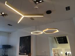 Tri is a triangular shaped pendant light constructed from brass channel. Shadi Home Lighting