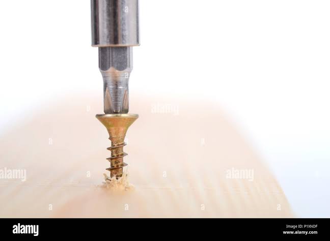 Wood Screw being screwed into a wood , Carpenter woodwork, screwing concept  Stock Photo - Alamy