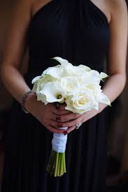 Greenery added a verdant pop of color to the otherwise monochromatic look. All White Calla Lily And Rose Bouquet