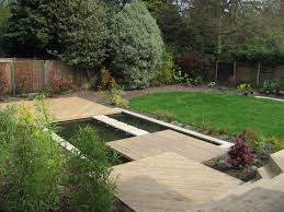 Sloping Away From The House In This Small Garden The Slope Was Managed By Creating A Series Of Timbe Sloped Backyard Landscaping Sloped Garden Sloped Backyard
