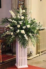 Church altar with red and white flowers and lit christmas trees. Pin On Floral Design Business