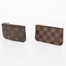 Different prints but i'm pretty sure the design applies to all key pouch canv. Louis Vuitton Two Pochette Cles Key Pouches One In Monogram And The Other One In Damier Ebene Canvas Bukowskis