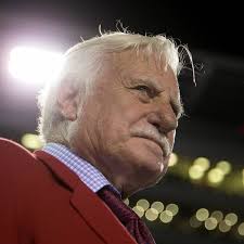 University of miami head coach howard schnellenberger and quarterback jim kelly run through the smoke. Ef3pqqzvqsp74m