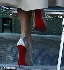 Melania wore a belted red coat layered over a black dress. Melania Trump Changes Into Another Pair Of Louboutin Pumps In Belgium Express Digest