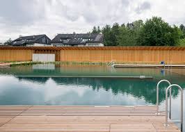 Herzog De Meuron Creates Natural Swimming Pool In Switzerland Swimming Pool Architecture Natural Swimming Pool Swimming Pools