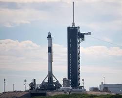 Image of Falcon 9 rocket landing vertically on a landing pad