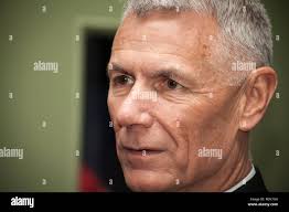 Lt. Gen. Rex C. McMillian, commander of Marine Forces Reserve presents the  Purple Heart to the families of Gunnery Sgt. Thomas J. Sullivan, Staff Sgt.  David Wyatt, Sgt. Carson Holmquist, Lance Cpl.