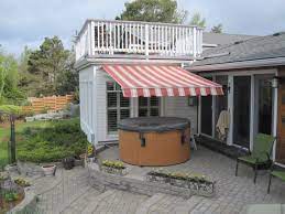 Even When Its Raining Outside Or You Want Protection From The Sun Enjoy Your Hot Tub With A Retractable Awning Yard Design Outdoor Living Retractable Awning