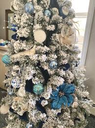 Check spelling or type a new query. Elegant Flocked Christmas Tree With Blue And Silver Decorations