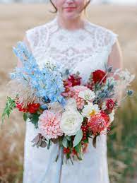 These traditionally dark red bottles look beautiful alongside a bouquet of pinot gris: Unexpected Wedding Bouquet Color Combinations That Will Make Your Arrangement Pop Red Bouquet Wedding Poppy Wedding Bouquets Summer Wedding Bouquets