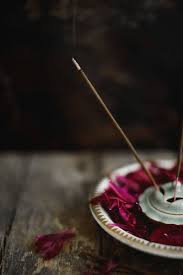 How to burn incense sticks. Burning Incense Stick Inside Bowl With Peonies Petals By Laura Stolfi For Stocksy United Burning Incense Incense Photography Incense