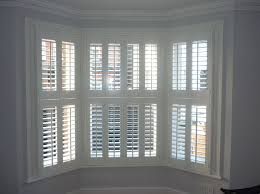 For eight windows at $45 to when buying shutters for bay windows, you will pay around $800 total. Bay Window In St Albans With White Wooden Tier On Tier Shutters Interior Shutters Bay Window Shutters Window Shutters Indoor