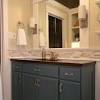 In this neutral bathroom, a dark gray paint color, which matches the slate floor tiles, stretches partway up the wall to give a sense of architecture. 1