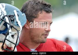 Philadelphia Eagles quarterback Kevin Kolb, right, drops back to pass at  San Francisco 49ers defensive tackle Justin Smith, left, looks