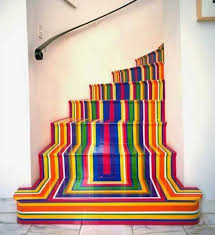 We love how on this staircase, the wood has been left bare in the centre and just pops of yellows have been painted onto the edges. Wooden Stairs With Painted Stripes Updating Interior Design In Creative Style