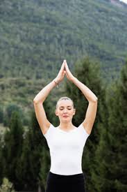 Maybe you would like to learn more about one of these? Woman Practicing Yoga Eyes Closed And Hands Together Stockphoto