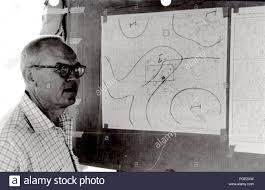 man examines national weather service wind charts 1961 stock