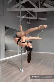 It's actually grown don't worry; Side View Of A Fit Attractive Caucasian Woman Enjoying Pole Dance Training At A Studio Hanging Upside Down On The Pole With Legs Outstretched Figure Health Stock Photo 397650214
