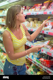 Young Woman Choosing Meat In Grocery Store Stock Photo Alamy