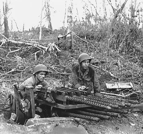 US soldiers inspect captured Japanese machine gun near Manila