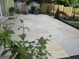 In this patio area, a repurposed workbench functions as a potting station, so fresh blooms are always within arm's reach. Patios And Paving Design Dublin Wicklow Landscaping Ie