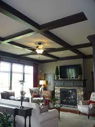 A circular brick pattern adds to the wagon wheel effect of the ceiling beams. Living Room Black Ceiling Novocom Top