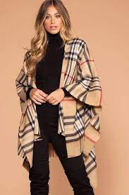 Spun from 100% soft lambswool, our highland store ruanas, known also as serape or wrap, grants a chic and timeless look. Highland Taupe Plaid Poncho Plaid Poncho Poncho Outfit Cape Outfit Fall