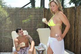Busty Blonde MILF Jodi West Wraps Her Arms Around A Young Stud And Blows  His Boner Poolside.  DefineBabe.com