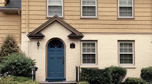 A small eclectic front porch with a pretty dark sherwin williams naval blue door; Exterior Color Inspiration Accent Paint Colors Sherwin Williams
