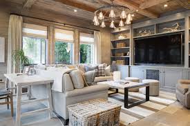 A living room decorating scheme truly fit for a snow queen, the wintry whites and silvers of this rustic chic living room are anchored by comfy fabrics and an unvarnished wooden table. Desk Behind Sofa Cottage Living Room Kelly Nutt Design