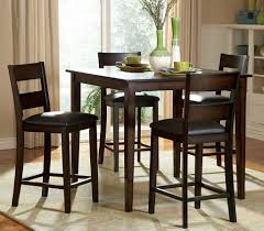 Since the two end chairs at a dining room table are traditionally equipped with arm rests, they're a natural pair to swap out for something a little bit less expected. High Chair Dining Room Set High Dining Table Tall Kitchen Table Tall Dining Table