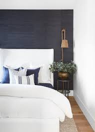This inky blue is named after the norfolk beach where the mud along with the cockles share a particular deep navy for the boy's bedroom a feature wall in resene blumine, a deepwater blue, glows in the sunshine. White Wingback Bed On Navy Blue Grasscloth Wallpaper Cottage Bedroom