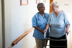 Nurse Assisting Patient In Walking With Walker At Retirement Home Nurse Assisti Aff Patient Walking Nurse Assisting Home Nurse Patient Retirement