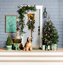 The simple wreath on the front door, made of evergreens, pine cones, gold ornaments, and a pretty bow gives the door a natural rustic look. Pretty Christmas Door Decorations Better Homes Gardens