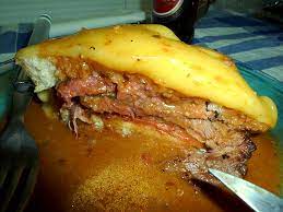 Two slices of bread, untold layers of meat, melted cheese and a sometimes spicy beer infused sauce, there really isn't anything better if you feel your cholesterol levels dropping. Francesinha Wikipedia