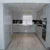 Traditional style kitchen cabinets with gold pulls were combined with a modern modular kitchen island in gunmetal gray. 1